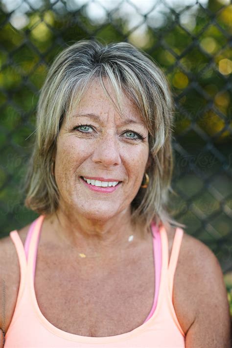 Smiling Mature Woman Wearing Tank Top By Stocksy Contributor Rob