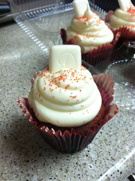 red velvet cupcake with cream cheese icing and a white