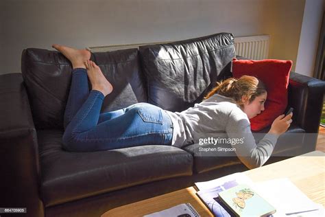 Girl On Couch With Smart Phone Photo Getty Images