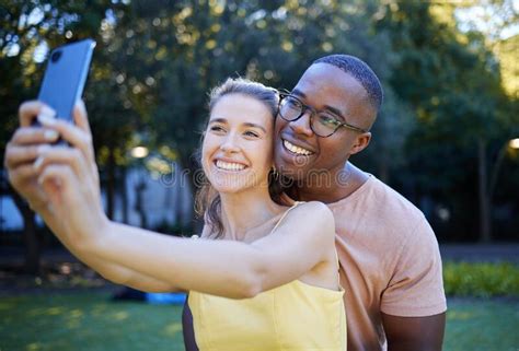 Selfie Phone And Interracial Couple Smile In Park Enjoying Weekend