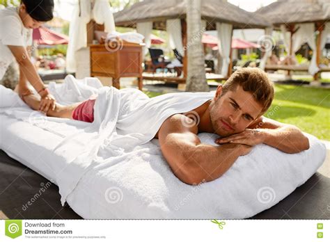 spa  man happy male relaxing outdoors  day spa stock photo