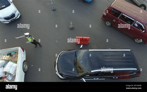 aerial photo of the traffic police directing the direction of vehicles