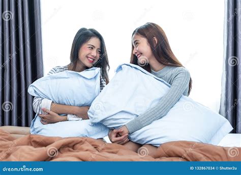 two asian lesbian looking together in bedroom beauty concept stock