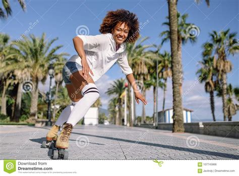 Black Woman On Roller Skates Rollerblading In Beach