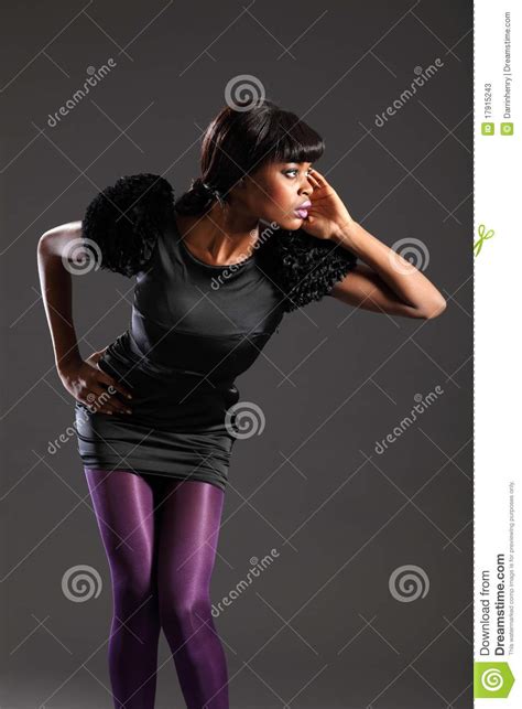 fashion model in purple tights black dress stock image