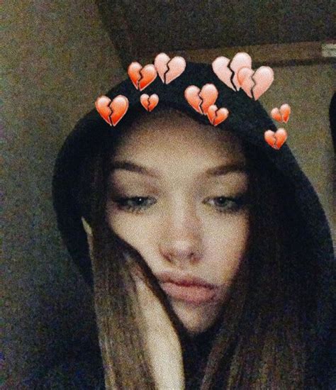 A Girl Wearing A Black Hat With Hearts On It