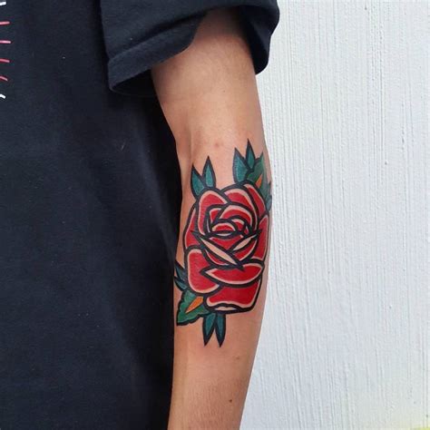 bold traditional red rose tattoo   left forearm