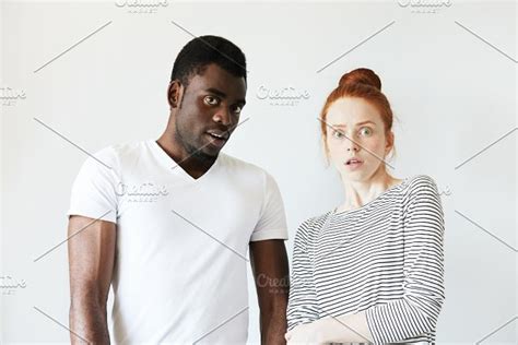 Black And White Headshot Of African Man And Caucasian Woman Standing