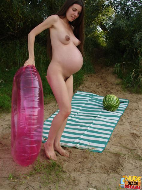 pregnant woman shows off her big stomach plus her juicy pussy whilst soothing found on the beach