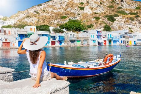 woman enjoys the panoramic view to the town of mykonos