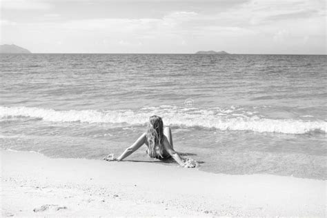 Beautiful Girl In Bikini Posing On A Deserted Beach White Sand