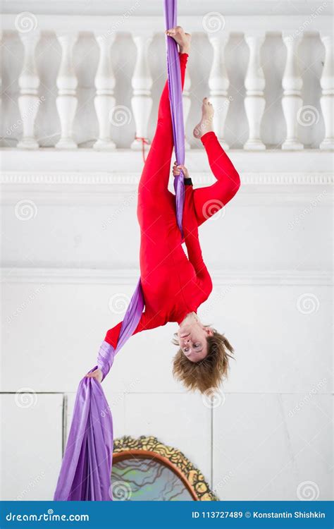 Young Attractive Woman Hangs Upside Down On The Aerial Silk Stock Image