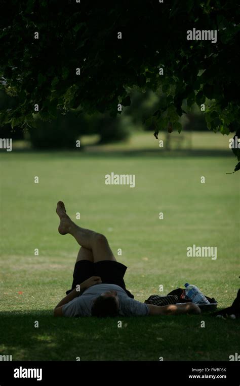 Summer Heatwave And Members Of The Public Cool Off In The Shade Where