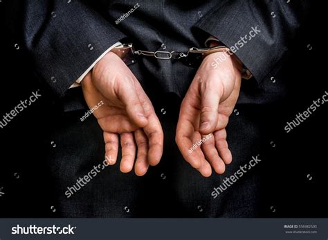 arrested businessman handcuffs hands behind back stock