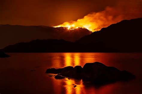 forest fire  night reflecting  nearby lake drax