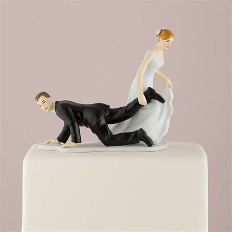 comical couple with the bride having the upper hand cake