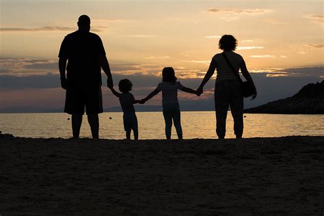 family   beach holding hands  sunset photograph  newnow