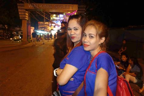 two sexy filipina massage ladies at the front of walking street fields ave angeles city