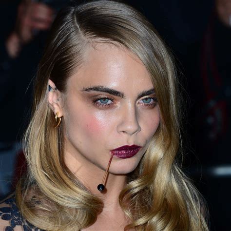 cara delevingne debuts a bizarre mouth accessory at the gq men of the