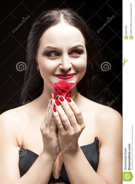 Portrait Of And Sensual Brunette Woman Posing With Red Flower Stock