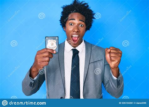Handsome African American Man With Afro Hair Holding Detective Badge