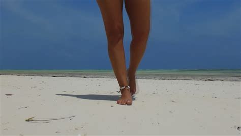 female legs standing by the sea on the beach stock footage