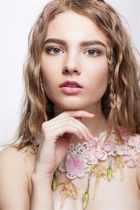 close up portrait of teen girl with flower necklace stock