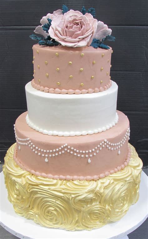 dusty pink and white tiers with a gold rose shaped tier in