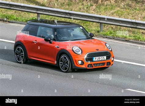 orange mini cooper sport uk vehicular traffic road transport