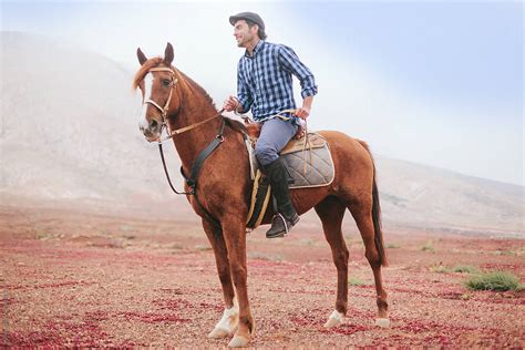 man riding  horse   desert area  stocksy contributor mattia