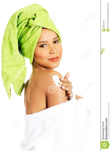 attractive woman rubbing a body lotion on her arm side view stock images image 35044124