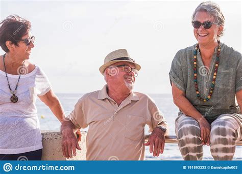 Group Of Three Seniors Having Fun Together Laughing And