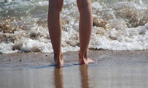 man dips foot  ocean water  contracts flesh eating