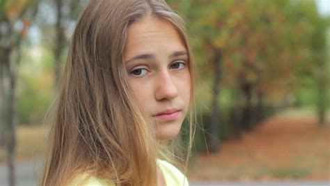 Sad Face Teenage Girl Looking At Camera Outdoors Close Up