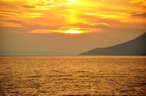 large body  water   boat   distance   mountain   background