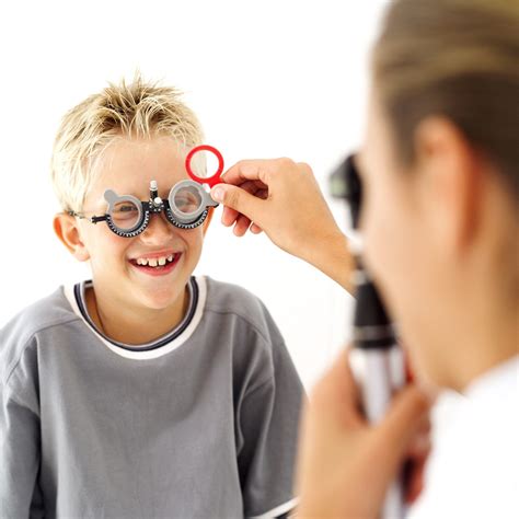young medical professional checking  eyes  young boy