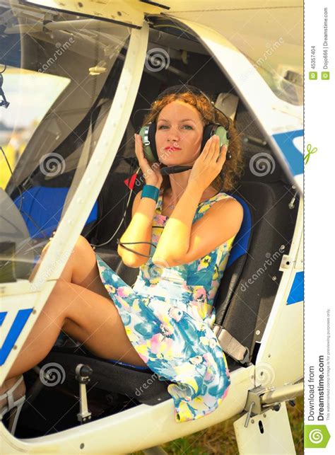 Beautiful Woman In Dress The Pilot In A Cockpit Of The