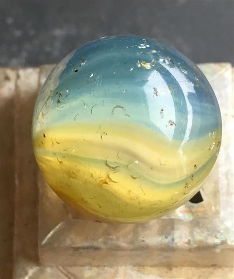 belle costes  instagram transitional shooter opalescent  blue  yellow glassmarbles