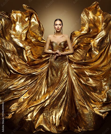 gold woman flying dress fashion model  waving golden gown fluttering fabric fly  wings
