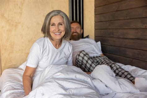 Mature Couple Staying In Bed And Feeling Close And Relaxed Stock Image