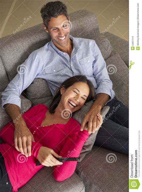 Hispanic Couple On Sofa Watching Tv Stock Image Image Of