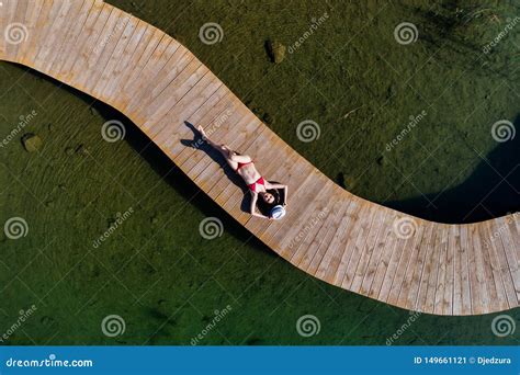 drone aerial view  young beauty woman sunbathing   sea pier stock image image