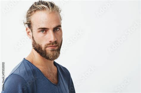 close up of beautiful swedish man with stylish hairstyle and beard in