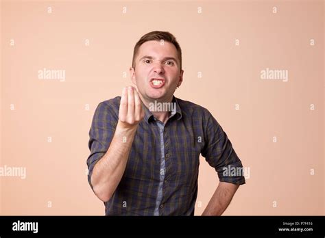 caucasian middle aged man  angry showing italian gesture