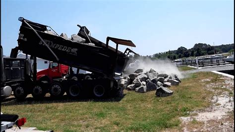 dump trucks unloading big rocks youtube