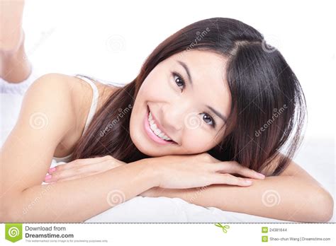 portrait of woman smile face lying on bed stock images
