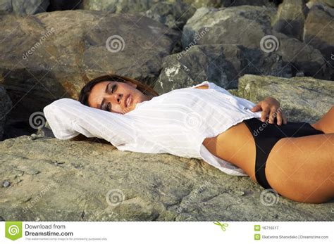 Beautiful Woman Laying On The Beach Rocks Royalty Free Stock
