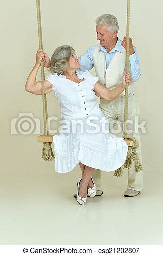 Elderly Couple On Swing Portrait Of Beautiful Elderly Couple On Swing