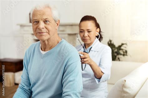 pleasant elderly man   medical examination stock photo