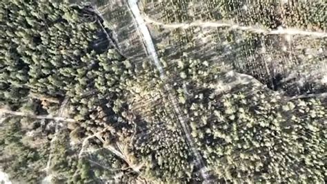 russian troops scramble  ukrainian drone drops bomb  trench